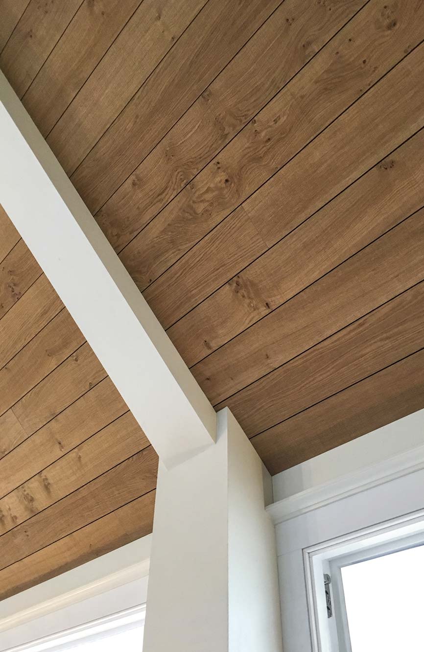 wood acoustic planks installed on a vaulted ceiling